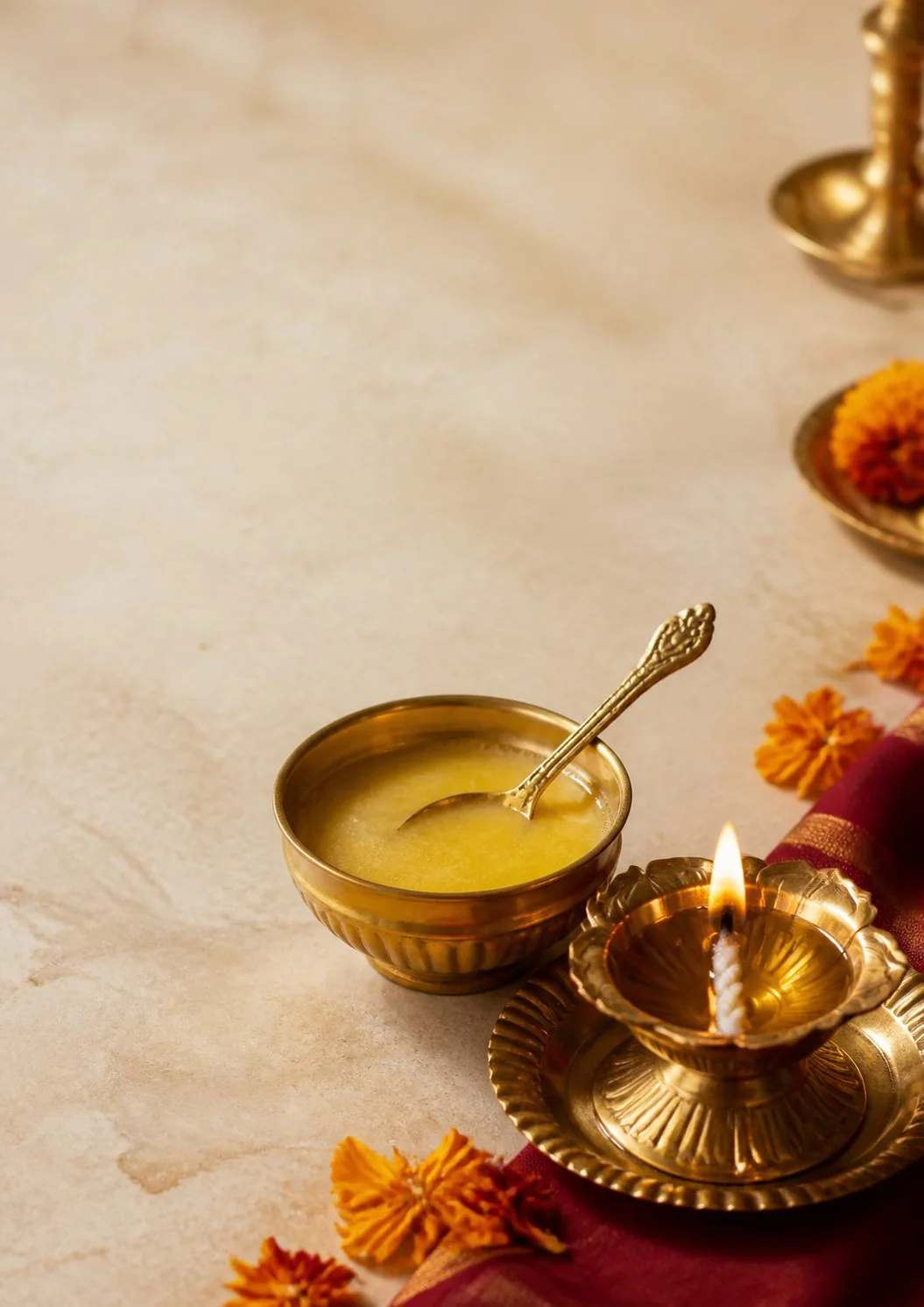 A bowl of cow ghee beside a traditional brass lamp — AI editorial illustration